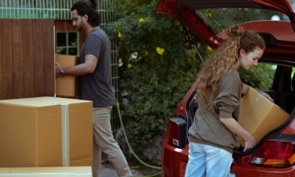 man and woman transferring boxes